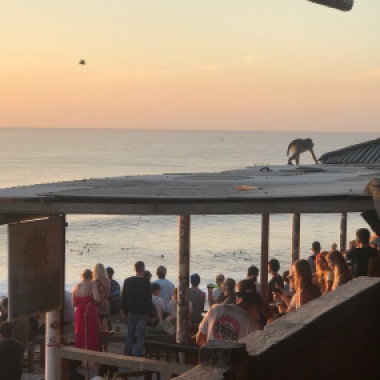 Everyday a crowd gathers to watch the surfers during sunset